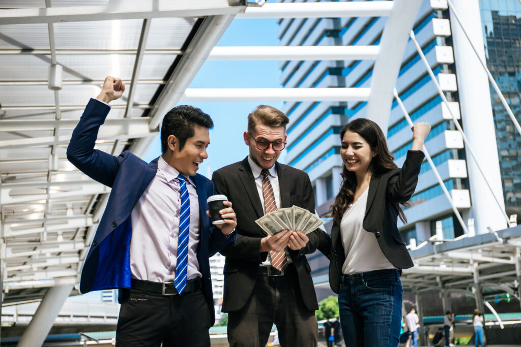 A group of entry-level customer service representatives celebrating with money